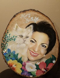 a painting of a woman with a cat on a wood slice